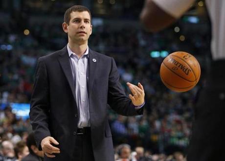 Boston Celtics head coach Brad Stevens flips the ball back to the referee during the second half of an NBA basketball game against the Miami Heat in Boston Saturday Feb. 27 2016