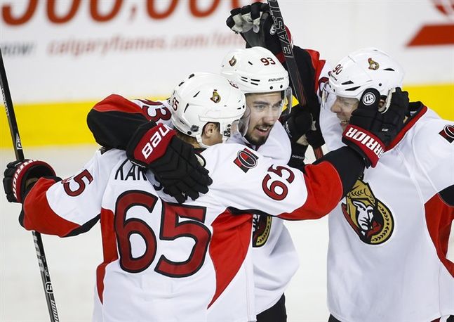 Ottawa Senators Mika Zibanejad centre of Sweden celebrates his goal with teammates Erik Karlsson left of Sweden and Alex Chiasson during third period NHL hockey action against the Calgary Flames in Calgary Saturday Feb. 27