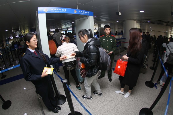 Medical staff pass out information about the Zika virus at Qingdao Airport in eastern China. The government has ordered the cleaning of public areas such as bus stations and markets to destroy the breeding grounds for the mosquito which carries the virus