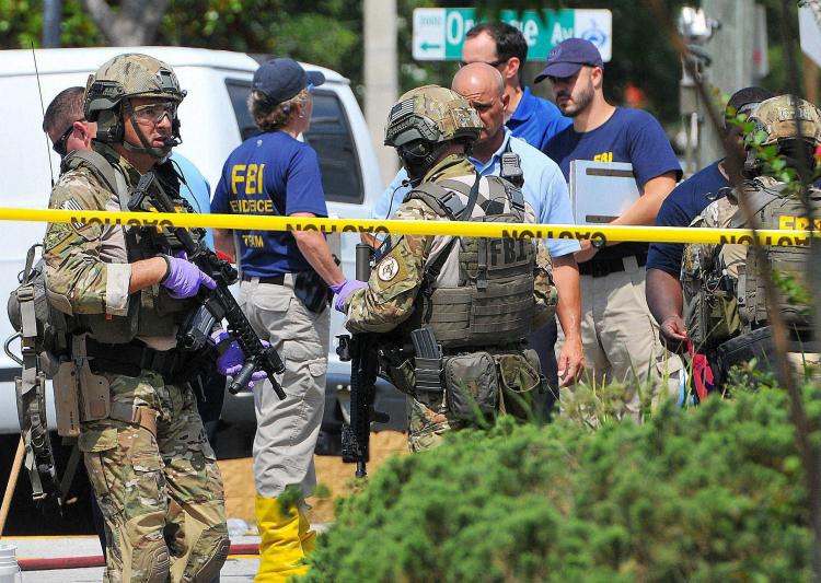 American security and FBI teams near the Orlando gay club where 50 people were killed by a shooter on Sunday. Credit PTI