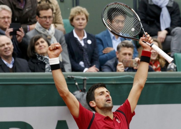 Djokovic celebrates in triumph his first in a semi-final on the secondary Suzanne Lenglen court forced on by a rain-disrupted week. — Reuters pic