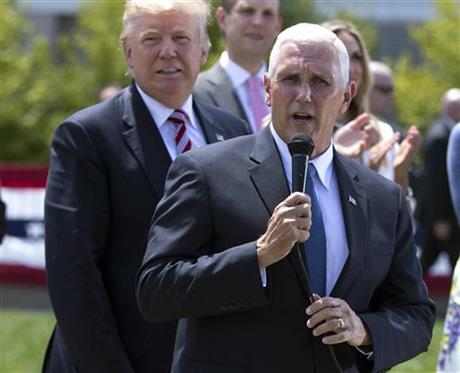 Republican presidential candidate Donald Trump left watches as vice presidential candidate Gov. Mike Pence R-Ind. speaks near the site of the Republican National Convention Wednesday