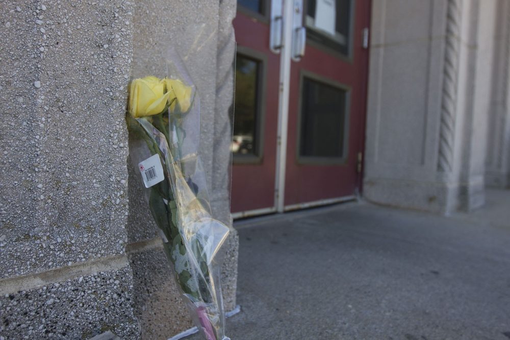 A lone flower is seen outside the Curley Community Center at Carson Beach in South Boston on Wednesday. The center's bathhouse is closed following the death of 7-year old Kyzr Willis