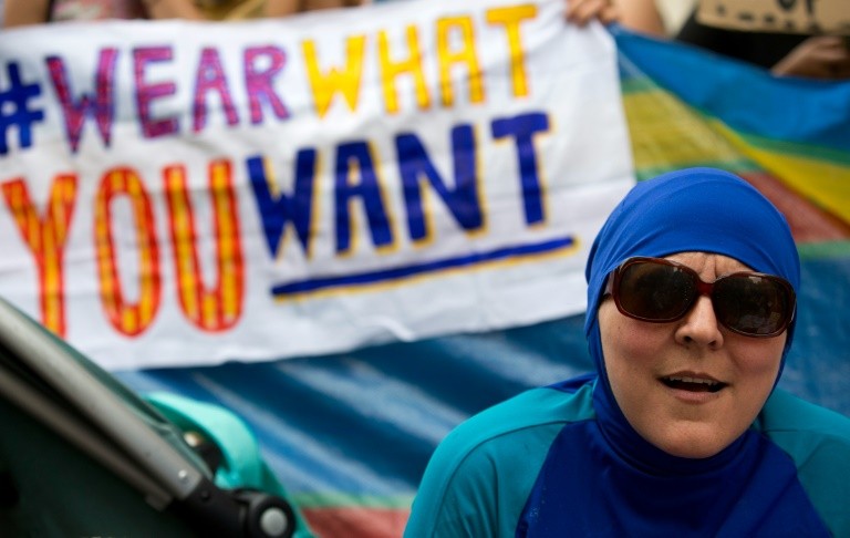 A woman wearing a burkini joins a protest outside the French Embassy in London