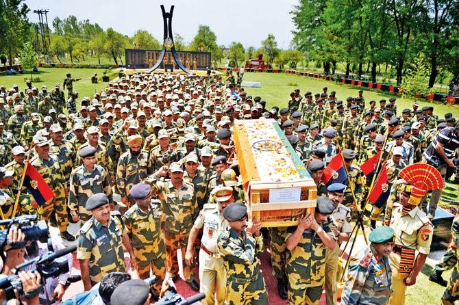 BSF soldiers shout slogans as they carry the coffin of a colleague after a wreath-laying ceremony in Srinagar yesterday. Pic  AFP