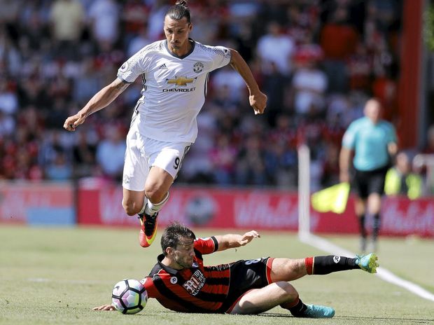 Manchester United's Zlatan Ibrahimovic left and Bournemouth's Harry Arter challenge for the ball