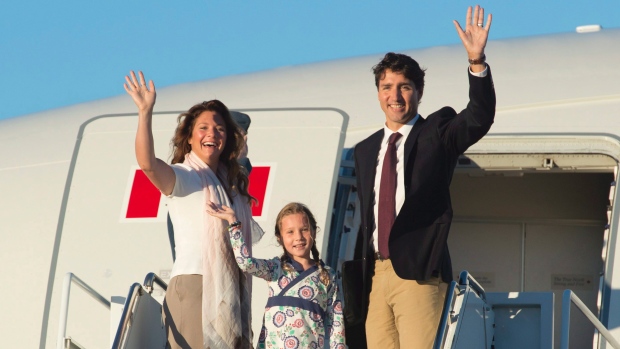 Canadian Prime Minister Justin Trudeau his wife Sophie Gregoire and daughter Ella Grace wave as they board a government plane in Ottawa Monday