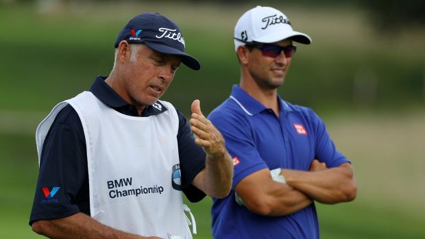 Adam Scott speaks with his caddie Steve Williams