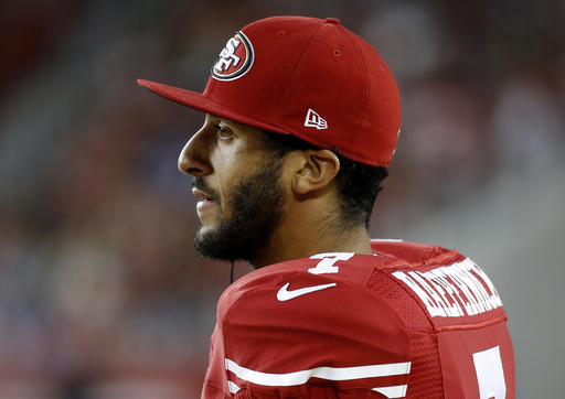 San Francisco 49ers quarterback Colin Kaepernick watches from the sideline during the second half of an NFL preseason football game against the San Diego Chargers in Santa Clara Ca