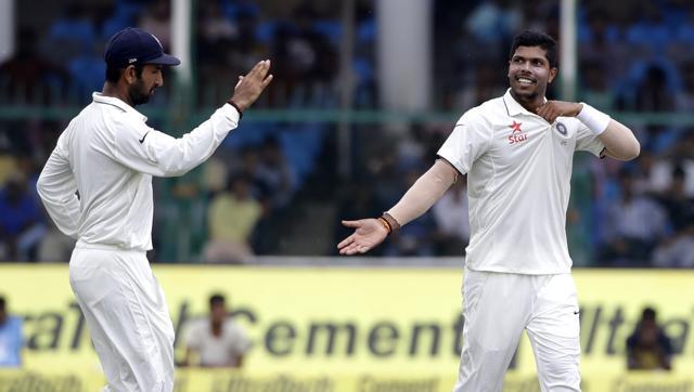 India's Cheteshwar Pujara left appreciates a good delivery by Umesh Yadav