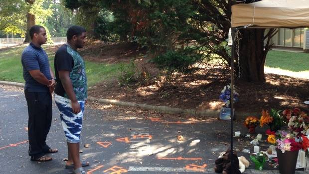 Members of the public pay their respects at a memorial to Keith Scott after he was shot dead by police