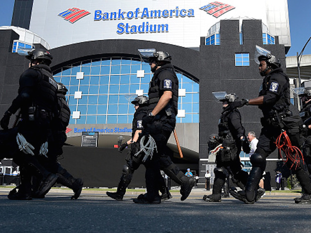 Police in riot gear on hand as protesters, fans interact outside NFL game in Charlotte