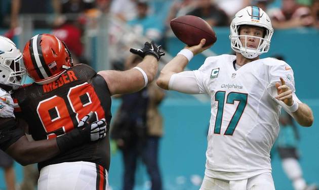 Miami Dolphins quarterback Ryan Tannehill looks to pass as Cleveland Browns defensive end Jamie Meder attempts to block it during the first half of an NFL football game Sunday Sept. 25 2016 in Miami Gardens Fla