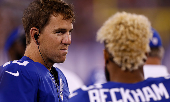 EAST RUTHERFORD NJ- SEPTEMBER 01 Eli Manning #10 and Odell Beckham #13 of the New York Giants stand on the sidelines during their preseason game against the New England Patriots at Met Life Stadium