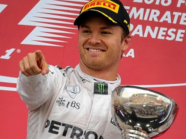 German driver Nico Rosberg of Mercedes celebrates with his trophy after winning the Japanese Grand Prix at Suzuka