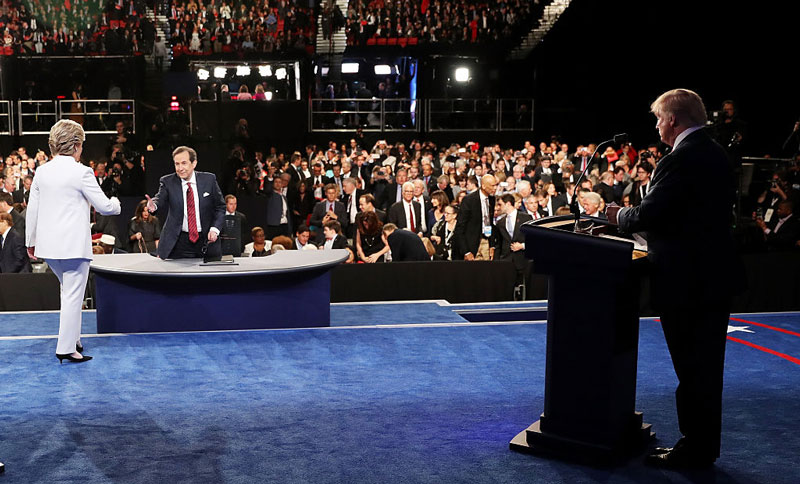 Debate moderator and Fox News host Chris Wallace greets the candidates at Wednesday night's final presidential debate