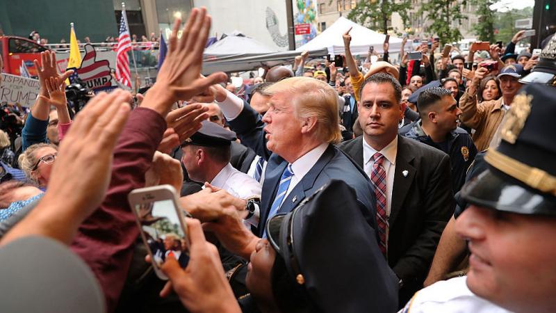 Donald Trump greets supporters outside of Trump Towers in Manhattan