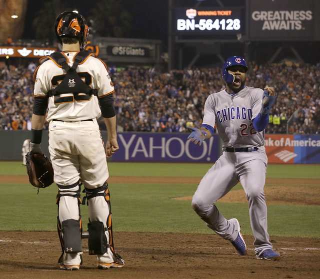 Jason Heyward celebrates after scoring during the ninth beside Buster Posey