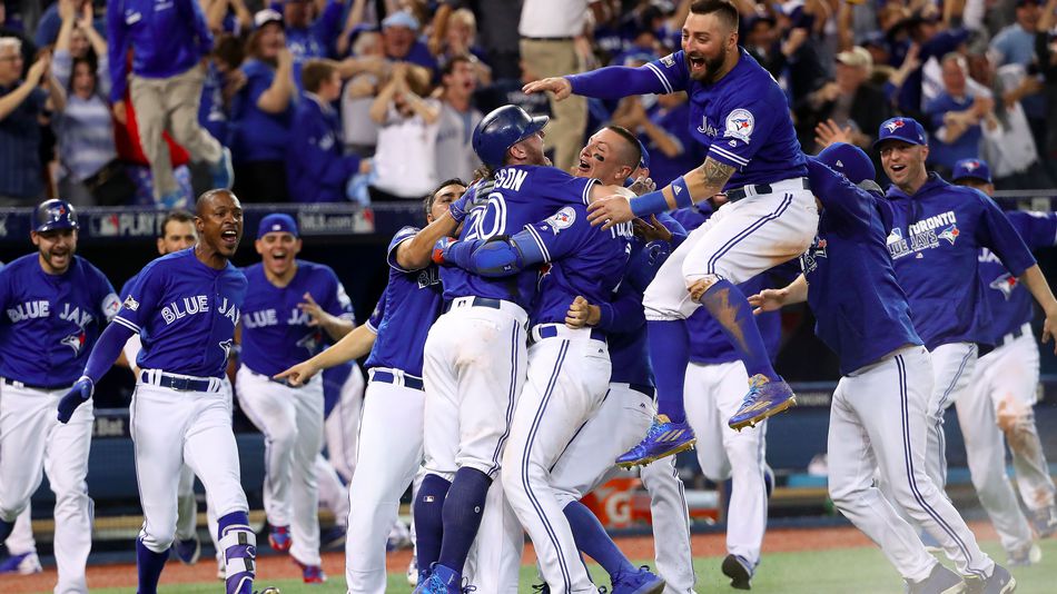 Josh Donaldson is swarmed by his teammates after the Toronto Blue Jays walk-off win