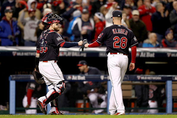 Corey Kluber #28 and Roberto Perez #55 of the Cleveland Indians react after the top of the fourth inning against the Chicago Cubs in Game One of the 2016 World Series at Progressive Field