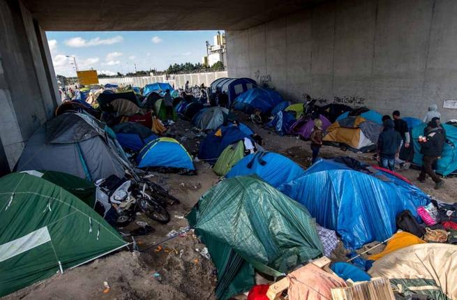 Migrant tents below a bridge in the Calais