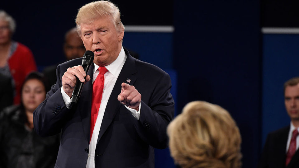 Mr Trump points in the direction of Ms Clinton during the debate