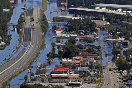 Floodwaters from Hurricane Matthew covers parts of Interstate 95 and homes and businesses in Lumberton N.C. Wednesday Oct. 12 2016. People were ordered to evacuate and officials warned that some communities could be cut off by washed out roads or bri