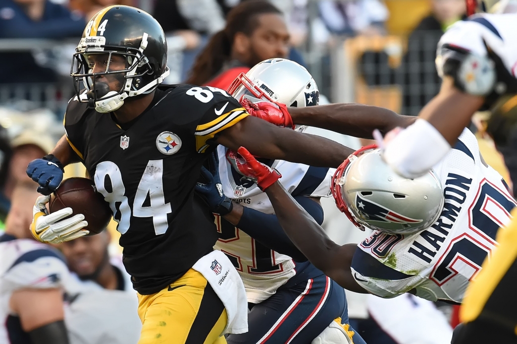 Peter Diana  Post-GazetteAntonio Brown fights off tacklers in the second quarter