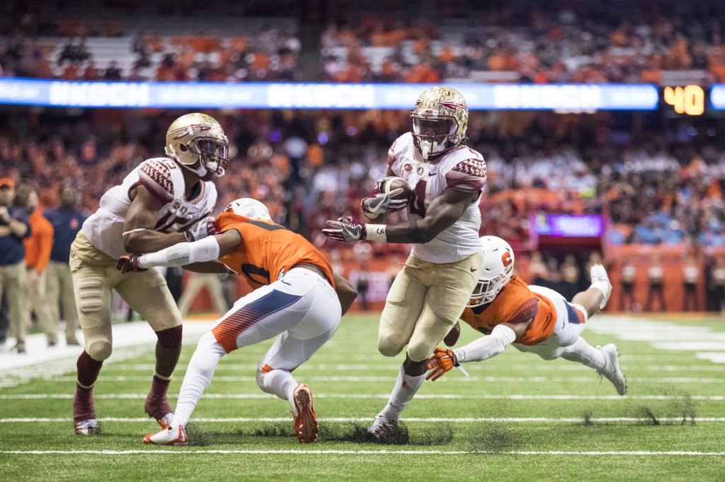 SYRACUSE NY- NOVEMBER 19 Dalvin Cook #4 of the Florida State Seminoles breaks a tackle to run in his final touchdown of the day against the Syracuse Orange during the third quarter