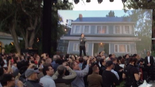 Elon Musk points out a solar roof on one of the movie set houses at Universal Studios Hollywood