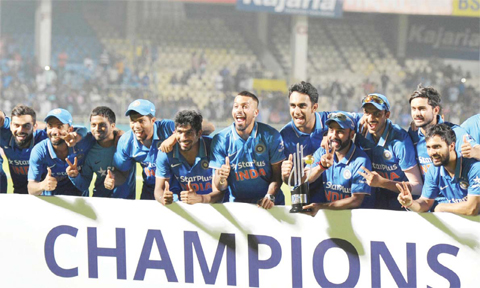 VISAKHAPATNAM India’s bowler Amit Mishra holds the winner’s trophy and poses with team members after India won the one day series 3-2 after the fifth one day international cricket match between India and New Zealand at Dr Y.S. Rajasekhara Reddy