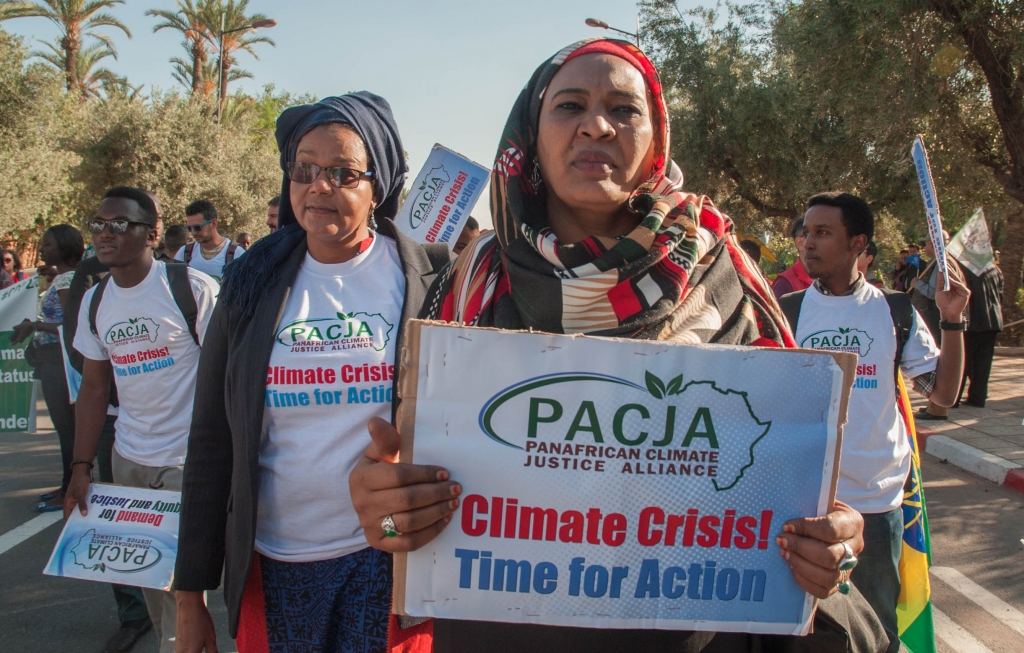 Activists hold banners at a demonstration for climate change and calling for environmental action in Marrakesh on the sidelines of the COP22 climate conference