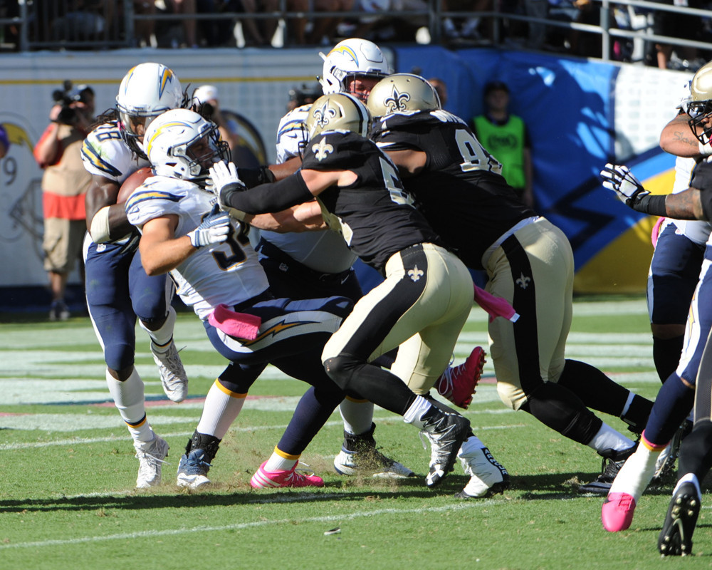 New Orleans Saints Linebacker Nathan Stupar and New Orleans Saints Defensive Tackle David Onyemata push San Diego Chargers Fullback Derek Watt backwards closing the running lane for San Diego Chargers Running Back Melvin G