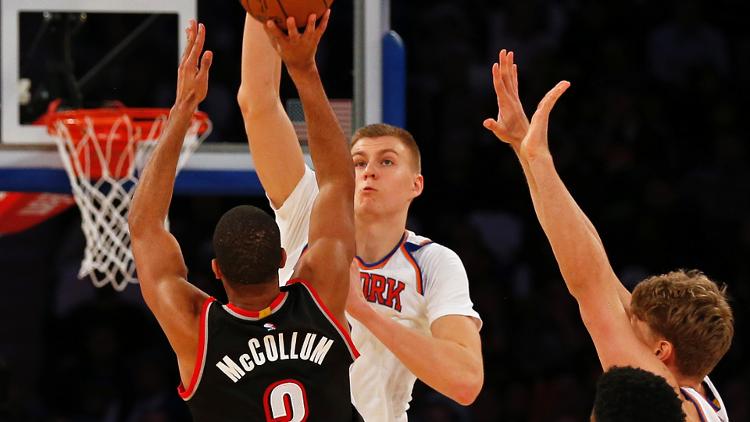 New York Knicks forward Kristaps Porzingis defends Portland Trail Blazers guard C.J. Mc Collum during the second half at Madison Square Garden