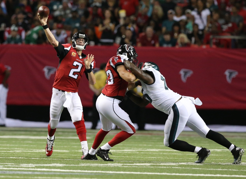 Sep 14 2015 Atlanta GA USA Atlanta Falcons quarterback Matt Ryan throws the ball behind the block of Jake Matthews on Philadelphia Eagles defensive end Vinny Curry in the second quarter at the Georgia Dome. Mandatory Credit Jason Getz