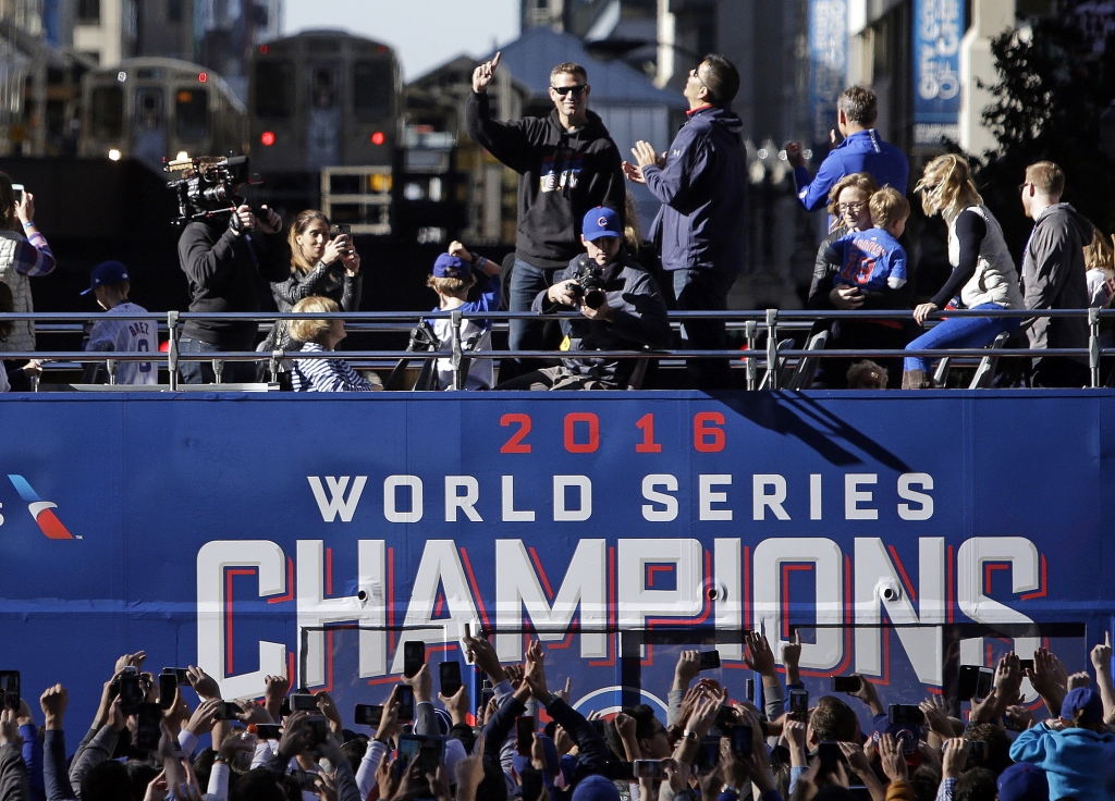 Chicago Cubs president of baseball operations Theo Epstein wave to fans during a parade honoring the World Series champions Friday Nov. 4 2016 in Chicago