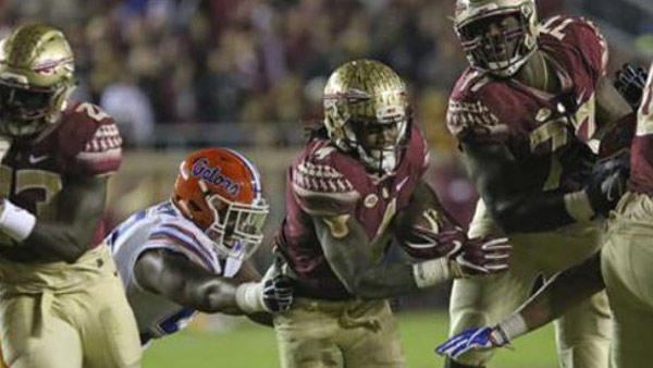 Florida State's Dalvin Cook center finds a hole in the Florida defense to score during the first quarter of an NCAA college football game Saturday Nov. 26 2016 in Tallahassee Fla