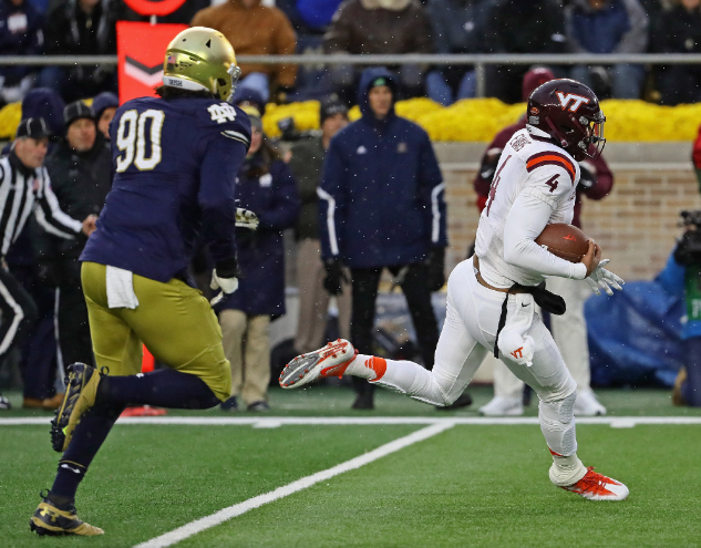 Virginia Tech's Jerod Evans runs away from Notre Dame's Isaac Rochell for a touchdown at Notre Dame Stadium. | Jonathan Daniel  Getty Images