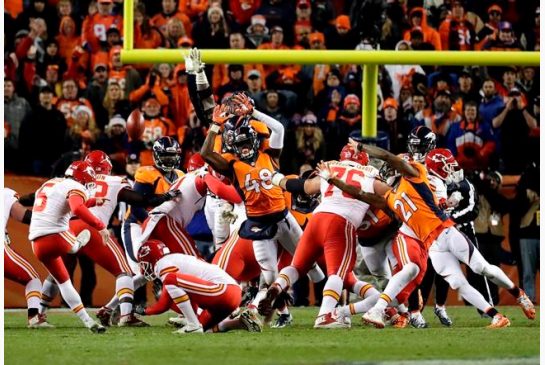 Kansas City Chiefs kicker Cairo Santos kicks the game winning field goal as punter Dustin Colquitt holds during overtime of an NFL football game against the Denver Broncos in Denver. The Denver Bron