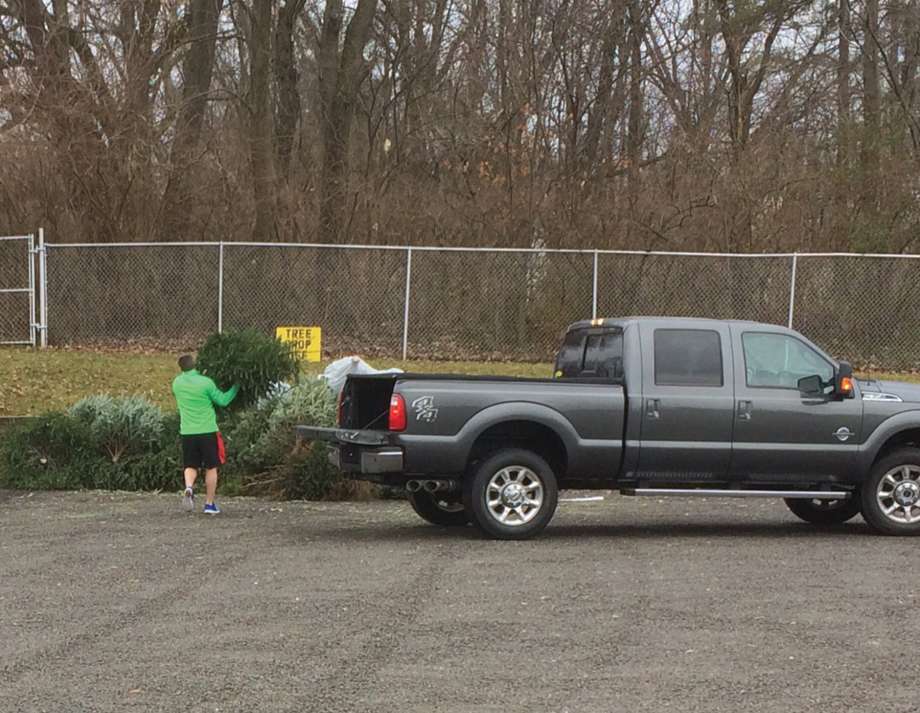 A man drops off a Christmas tree Wednesday at Edwardsville Township Park