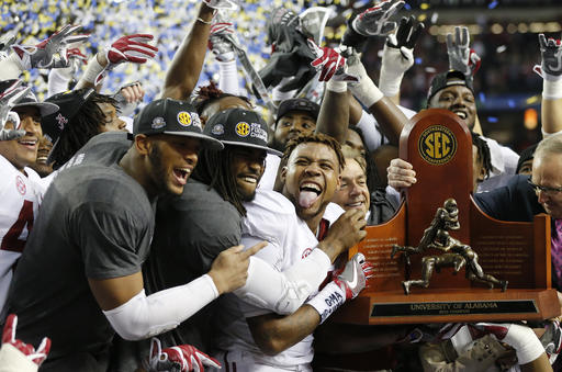 Alabama team members celebrate after the Southeastern Conference championship NCAA college football game against Florida Saturday Dec. 3 2016 in Atlanta. Alabama won 54-16