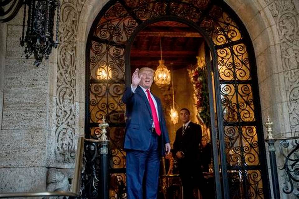 President-elect Donald Trump waves to members of the media after a meeting with admirals and generals from the Pentagon at Mar-a-Lago in Palm Beach Fla