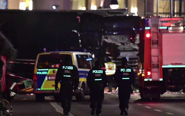 Police walk before the truck that had sped into a Christmas market in Berlin on 19 December 2016