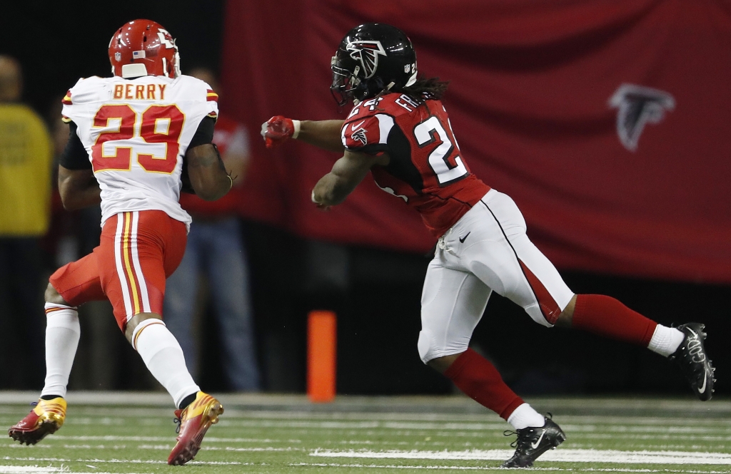 Kansas City Chiefs strong safety Eric Berry runs an intercepted ball against Atlanta Falcons running back Devonta Freeman during the first half of an NFL football game Sunday Dec. 4 2016 in Atlanta. Berry scored on the play. (AP