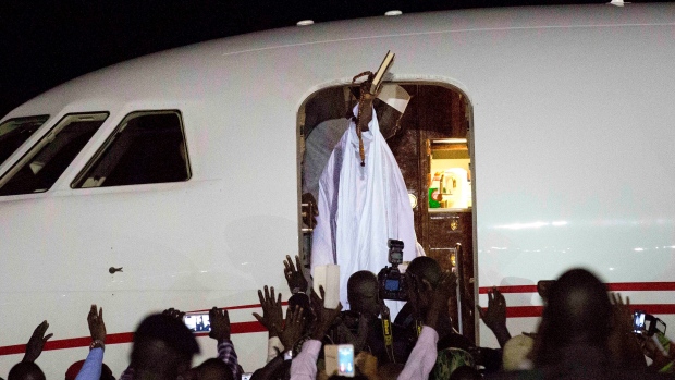 Gambia's defeated former leader Yahya Jammeh waves to supporters as he departs from the Banjul airport on Saturday. The flight came almost 24 hours after Jammeh announced on state television he was ceding power to the newly inaugurated Adama Barrow