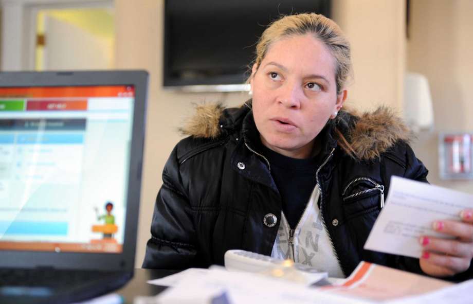 Abigail Salinas Lopez of Danbury tries to enroll her family in Access Health CT the state-based health insurance exchange that launched last year as part of the Affordable Care Act Wednesday Nov. 19 2014 at The Multicultural Center in Danbury. Conne