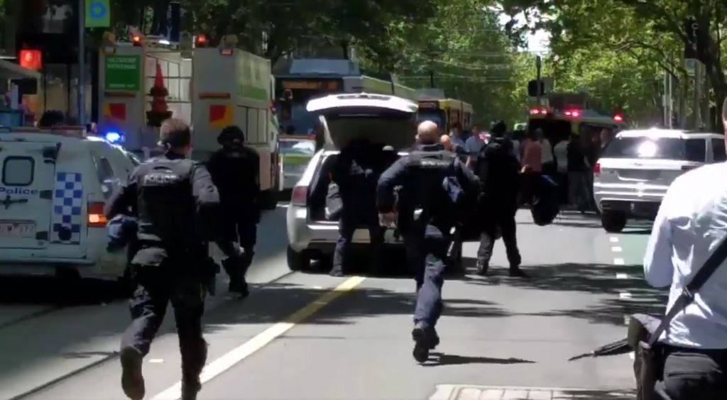 Police running to a scene where a car hit pedestrians in Melbourne Australia