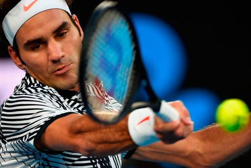 Roger Federer returns a serve during his Australian Open quarter-final victory over Mischa Zverev yesterday