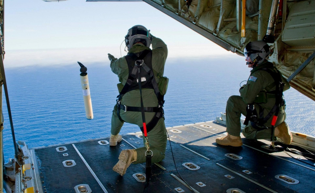 RAAF loadmasters launch marker buoys into the southern Indian Ocean