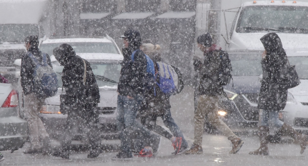 20170130dsSnowOaklandLocal02-4 University of Pittsburgh students crossing Forbes Avenue in Oakland during a light snowfall on Monday. Two to four inches of snow is expected Tuesday